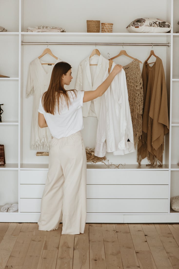 Young woman standing in front of her closet